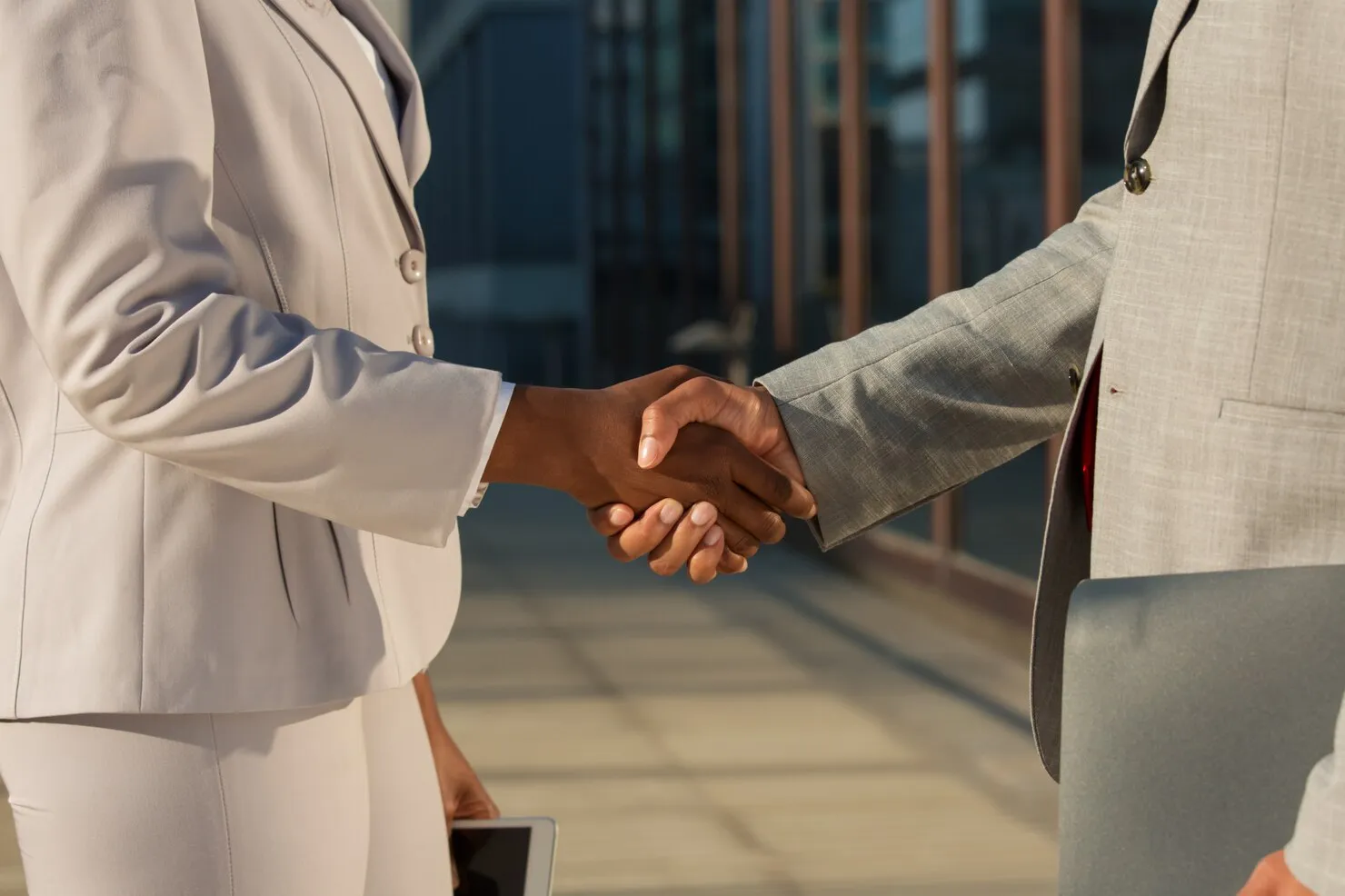 Business leaders shaking hands after a strategy and partnership conversation